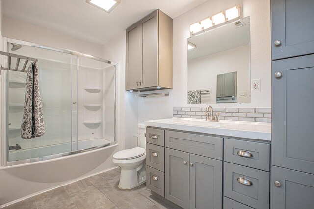 full bathroom with tasteful backsplash, vanity, enclosed tub / shower combo, and toilet