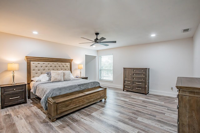 bedroom with ceiling fan and light hardwood / wood-style flooring