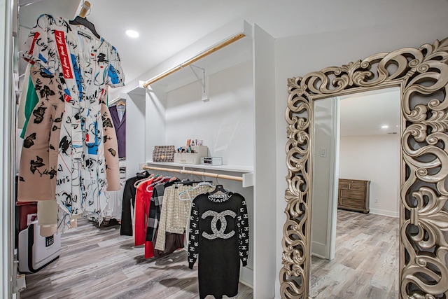 walk in closet with light wood-type flooring