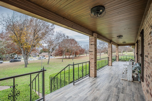 deck featuring a porch and a lawn