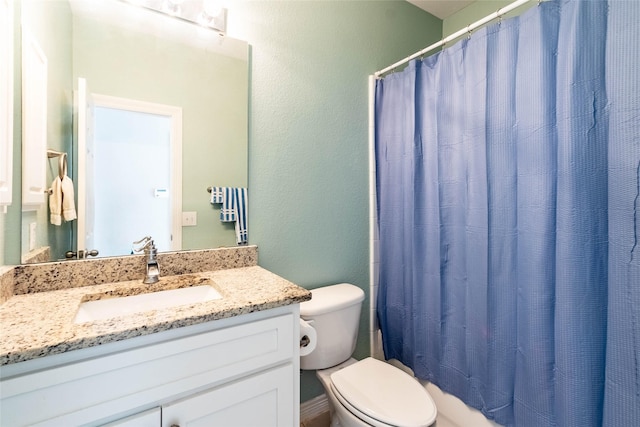 bathroom featuring vanity, a shower with shower curtain, and toilet