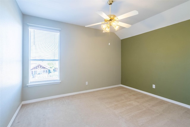 spare room featuring light carpet, ceiling fan, and lofted ceiling