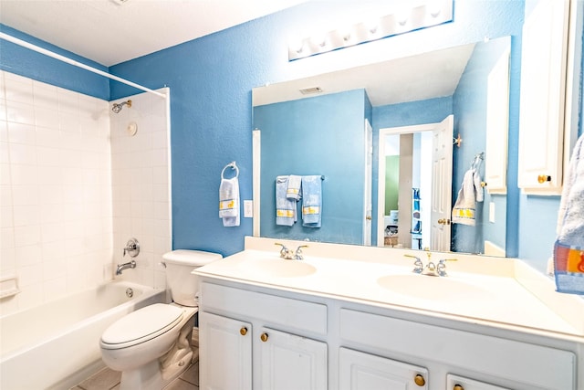 full bathroom featuring tile patterned floors, vanity, toilet, and shower / bathtub combination