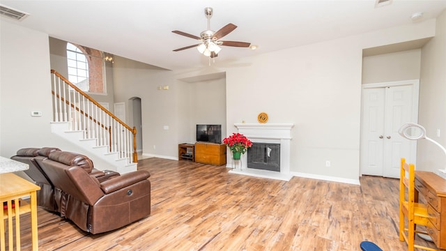 living room with light hardwood / wood-style flooring and ceiling fan