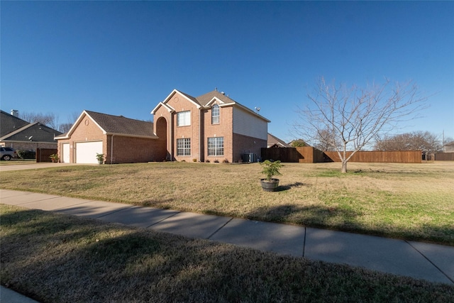 view of front of home with a front yard, a garage, and central air condition unit