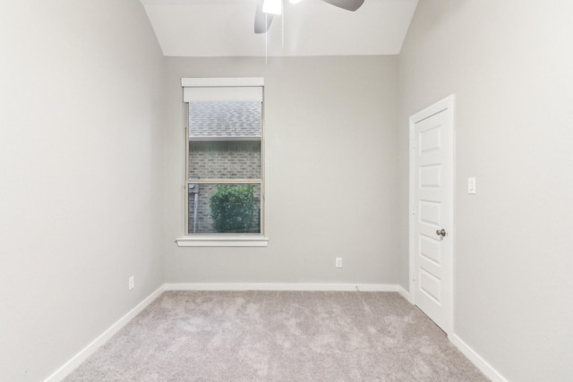 unfurnished room featuring light carpet, ceiling fan, and vaulted ceiling