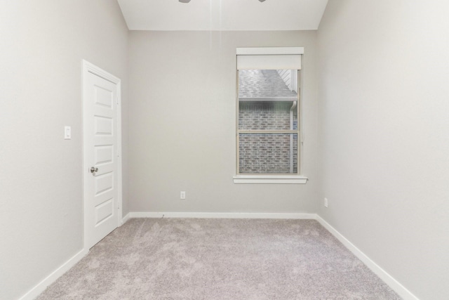 spare room with ceiling fan and light colored carpet