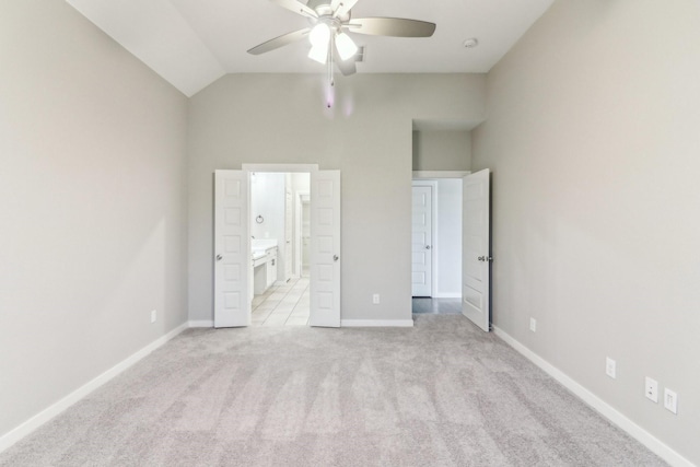 unfurnished bedroom featuring connected bathroom, light colored carpet, ceiling fan, and lofted ceiling