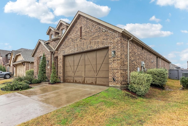 view of side of property with a garage and a lawn