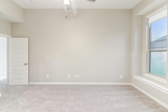 spare room with light carpet and ceiling fan