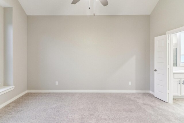 spare room featuring light carpet and ceiling fan