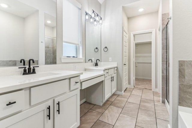 bathroom featuring tile patterned flooring, vanity, and a shower with shower door