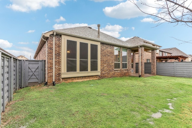 rear view of house with a yard