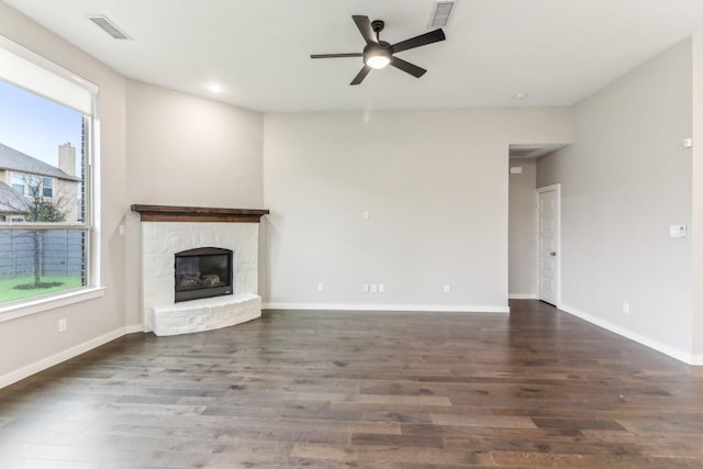 unfurnished living room featuring ceiling fan and dark wood-type flooring