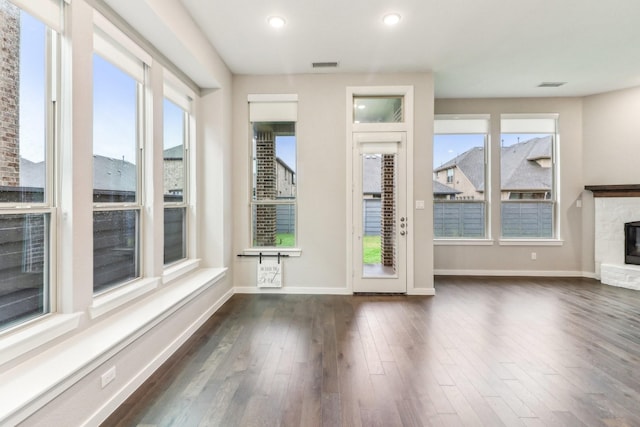 interior space with a fireplace and dark wood-type flooring