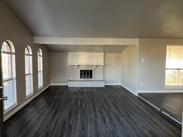 unfurnished living room featuring a fireplace and dark hardwood / wood-style flooring