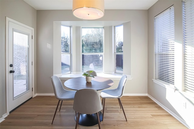 dining area with plenty of natural light and light hardwood / wood-style flooring