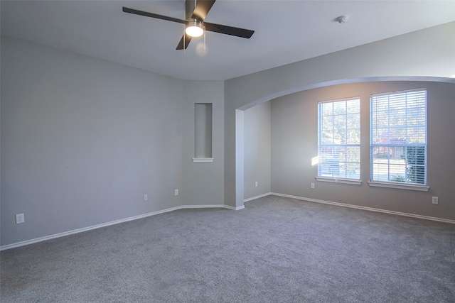 carpeted spare room with ceiling fan