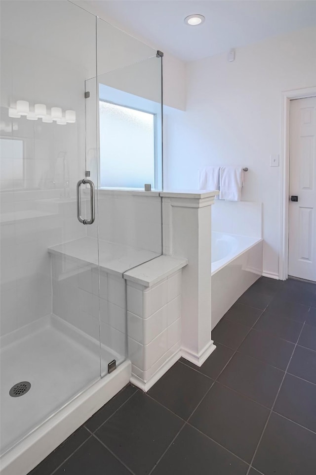 bathroom featuring tile patterned floors and separate shower and tub