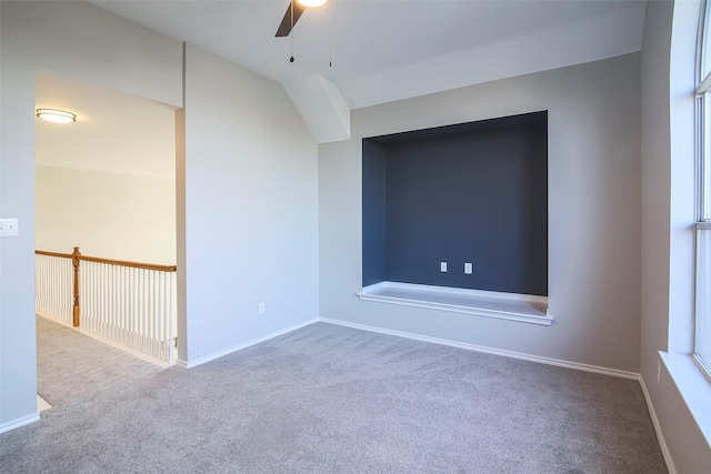 unfurnished room featuring carpet, vaulted ceiling, and ceiling fan