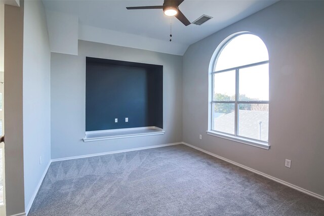 carpeted spare room featuring ceiling fan and lofted ceiling