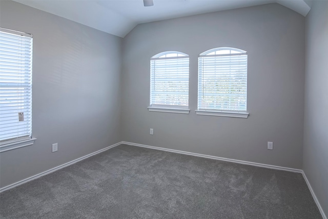 carpeted empty room featuring ceiling fan and lofted ceiling