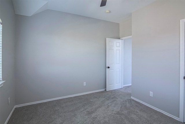 unfurnished room featuring dark colored carpet, ceiling fan, and lofted ceiling