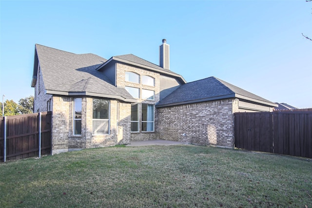 back of house featuring a yard and a patio