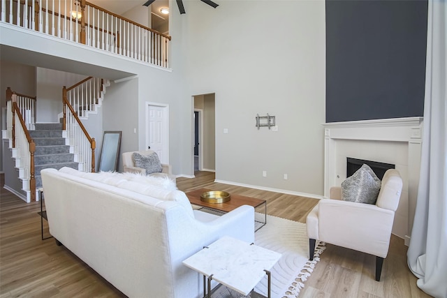 living room featuring a high ceiling and hardwood / wood-style flooring