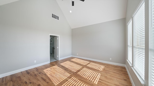 unfurnished room featuring ceiling fan, high vaulted ceiling, and light hardwood / wood-style floors