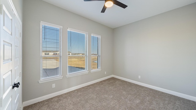 carpeted empty room with ceiling fan