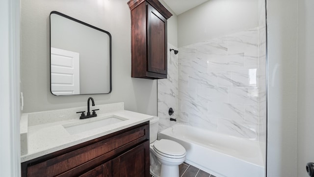 full bathroom featuring tiled shower / bath, vanity, and toilet