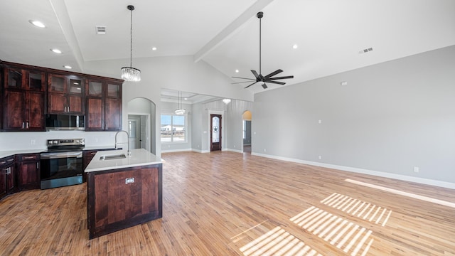 kitchen featuring stainless steel appliances, sink, a center island with sink, and light hardwood / wood-style flooring