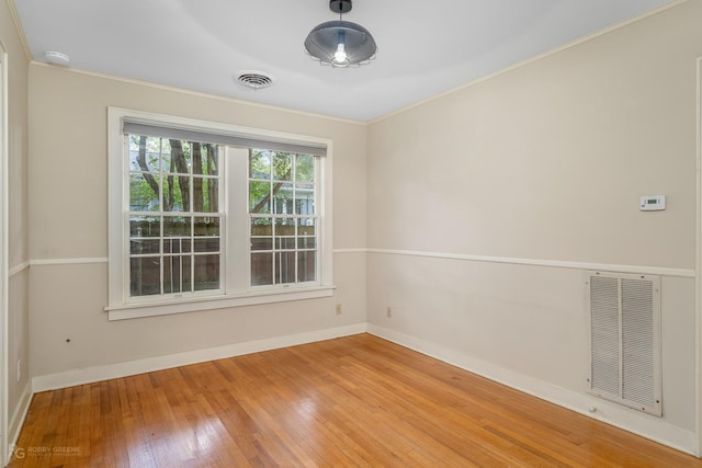 unfurnished room with light hardwood / wood-style floors and crown molding