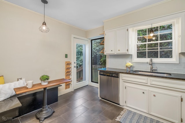 kitchen featuring pendant lighting, dishwasher, backsplash, sink, and white cabinetry