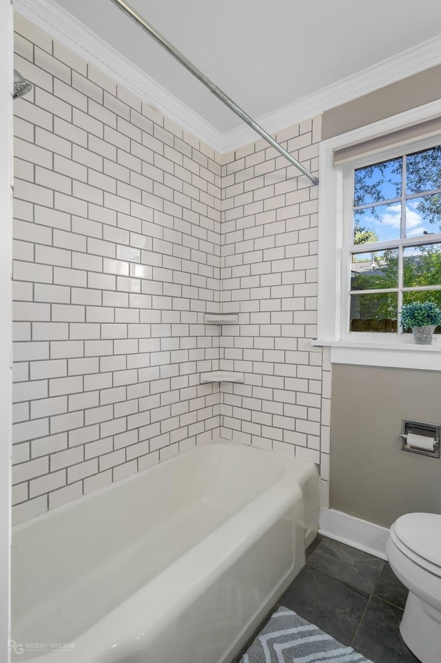 bathroom with tile patterned flooring, toilet, tiled shower / bath, and crown molding