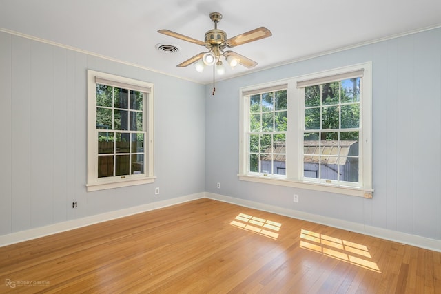 unfurnished room with light hardwood / wood-style flooring, ceiling fan, and crown molding