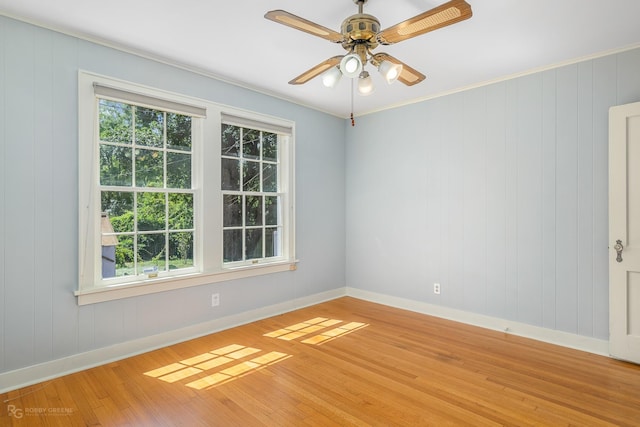 spare room with hardwood / wood-style flooring, ceiling fan, and crown molding