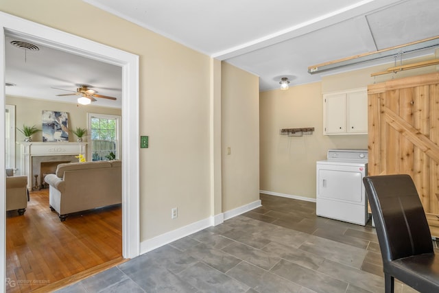 laundry area with washer / clothes dryer, ceiling fan, cabinets, and a barn door