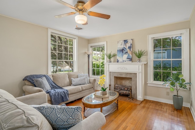 living room featuring ceiling fan and light wood-type flooring