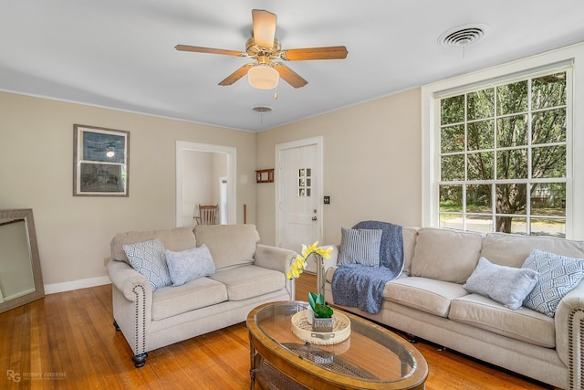 living room featuring hardwood / wood-style flooring and ceiling fan