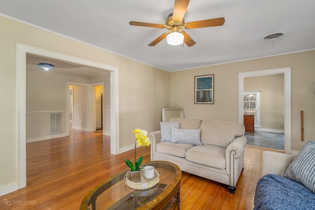 living room with ceiling fan and light wood-type flooring