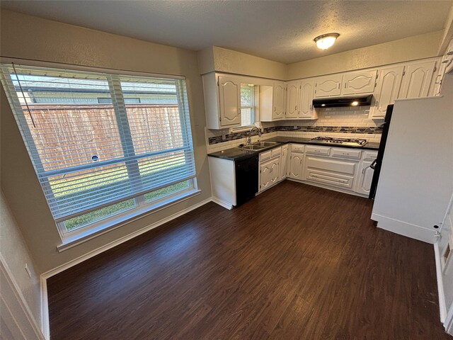 kitchen with dark hardwood / wood-style floors, white cabinetry, sink, backsplash, and stainless steel gas cooktop