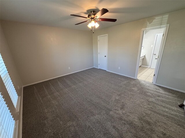 unfurnished bedroom with ceiling fan, light colored carpet, and ensuite bathroom