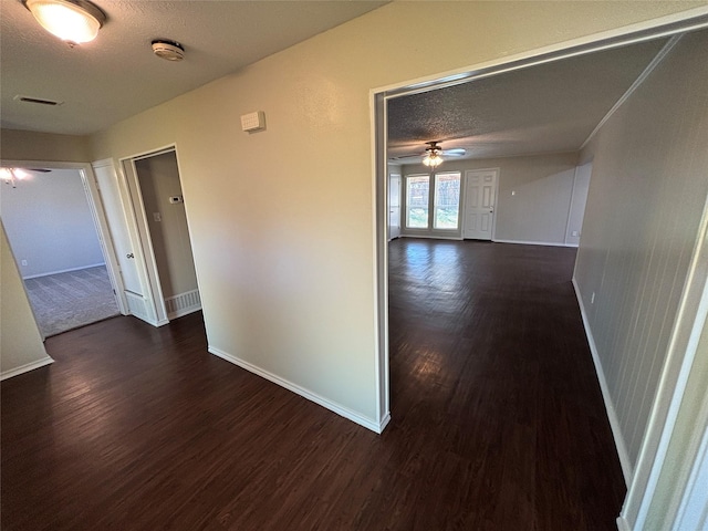 hall featuring dark hardwood / wood-style floors and a textured ceiling