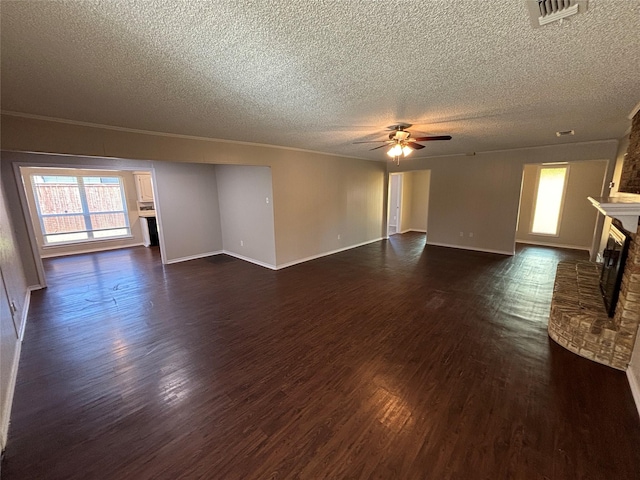 unfurnished living room featuring dark wood-type flooring, a fireplace, a textured ceiling, and ceiling fan