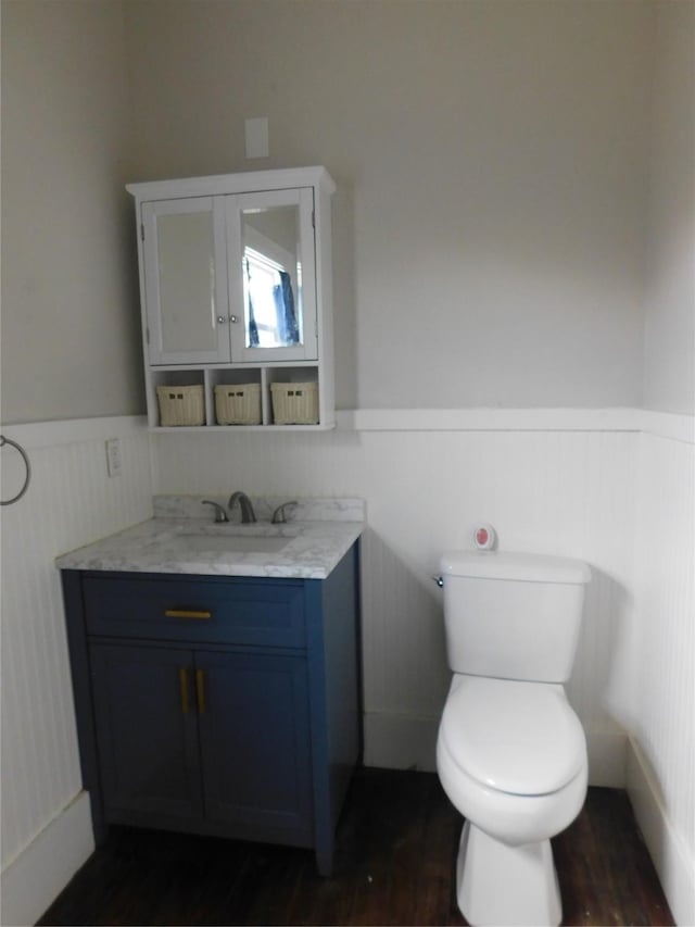 bathroom featuring hardwood / wood-style floors, vanity, and toilet