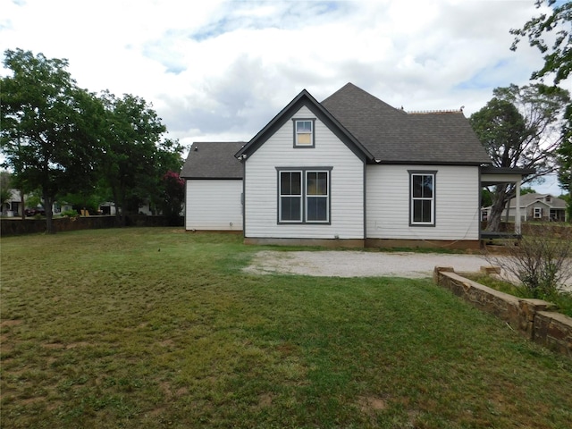 back of house featuring a lawn