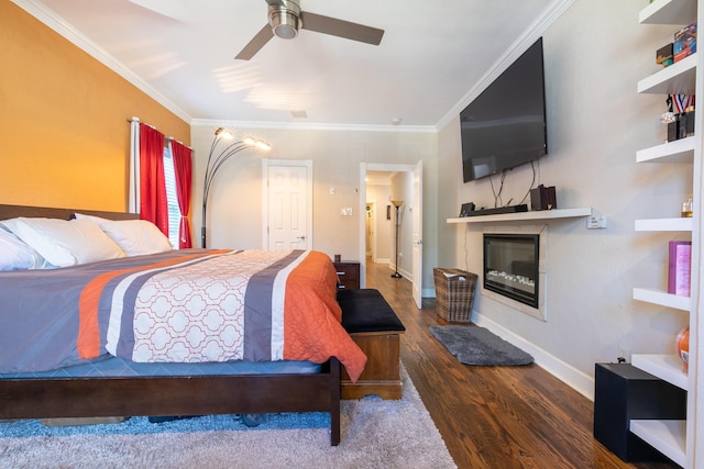 bedroom featuring dark hardwood / wood-style flooring, ceiling fan, and crown molding