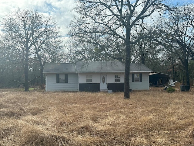 rear view of property featuring a carport